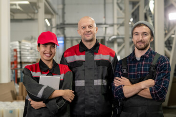 Fototapeta premium Group of successful and cheerful male and female engineers of large factory