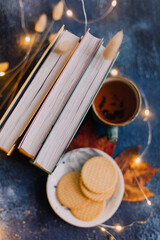 book and cup of tea on the color background