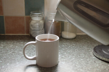Making a cup of tea, selective focus on the mug