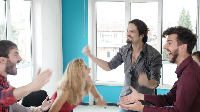 start up, career - young co-workers rejoicing at having found the solution