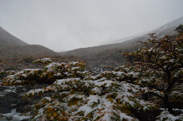 Hiking in the windy and snowy mountains of the Torres del Paine National Park in Patagonia, Chile