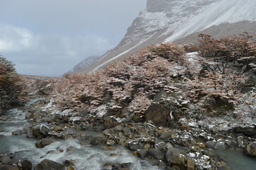 Hiking in the windy and snowy mountains of the Torres del Paine National Park in Patagonia, Chile