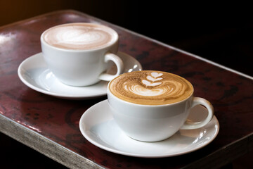 morning coffee in white cup on wooden table in cafe