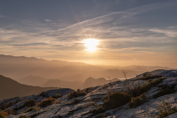 Stones and  Autumn vegetation at an altitude, in the mountains of Corsica with the sea in the background