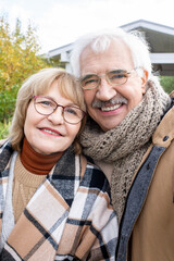 Cheerful senior man and woman in stylish warm casualwear looking at you