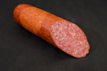 sausage stick floor on black wood table. Salami