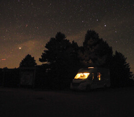 Camper van in the mountains with star