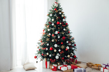 Christmas tree by the window with gift decor for the new year interior holiday card