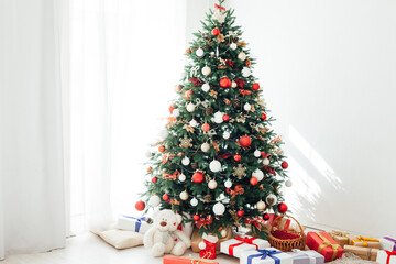 Christmas tree by the window with gift decor for the new year interior holiday card