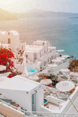 Houses in the mountains overlooking the sea and volcan in a sunrise oia santorini greece