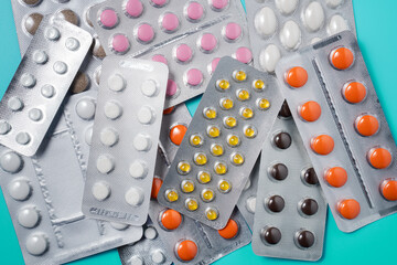 Pile of medical pills or tablets in plastic package, close up.
