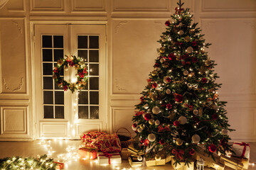 Fototapeta na wymiar Christmas tree shines lights garlands New Year's Night warm light