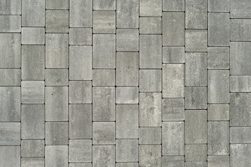Cobblestone texture. The sidewalk tile is evenly folded. Gray cobblestones close up.