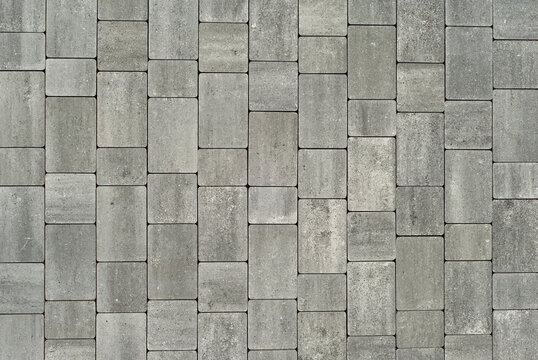 Cobblestone texture. The sidewalk tile is evenly folded. Gray cobblestones close up. - Powered by Adobe
