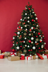 Fototapeta na wymiar Christmas tree pine decor red background New Year holiday gifts