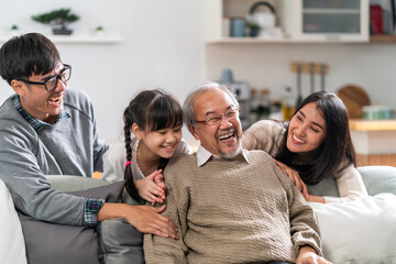 Happy multigenerational asian family portrait in living room - 384413049
