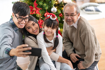Multigenerational Family selfie with Christmas tree