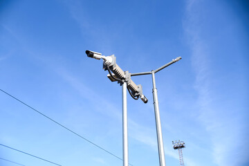 Fototapeta na wymiar CCTV cameras mounted on a pole, blue sky background. Two video cameras for outdoor surveillance.