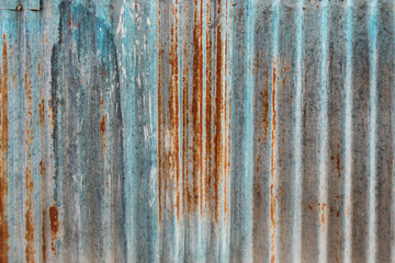 Old rusted galvanized metal sheet. Rusty surface caused by oxidation iron with blue and brown...