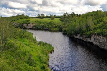 Fototapeta premium Alberta, Canada - Bucolic Castor River below Billowing Clouds