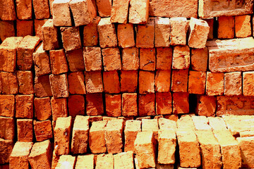 Stack of red bricks for construction purpose