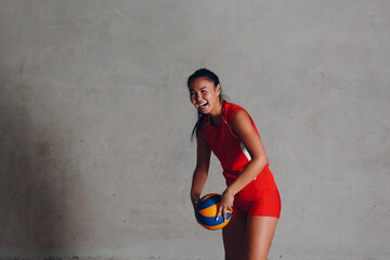 Young woman smiling volleyball player with ball