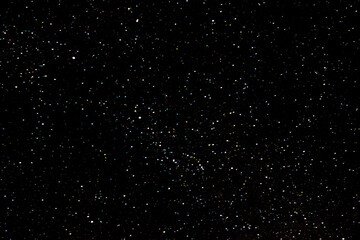 Stars on a dark night sky. Blurred, defocus. Abstract background