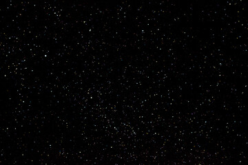 Stars on a dark night sky. Blurred, defocus. Abstract background