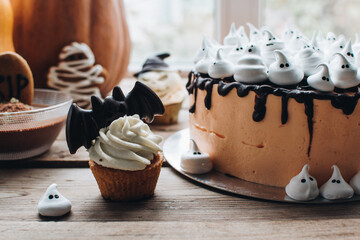 Sweets for halloween party on a wooden table. Halloween style party, candy bar and decorations with...
