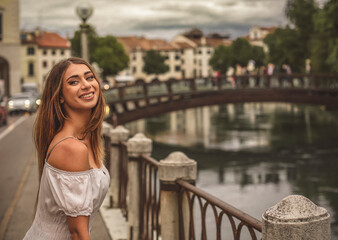 Smiling girl near the bridge