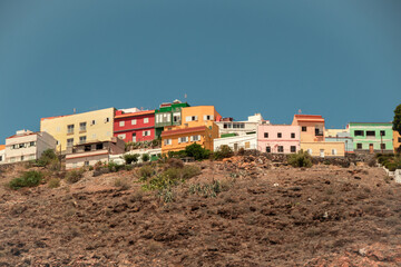 Fototapeta premium Colorful houses on a hill under the blue sky in San Sebastian, La Gomera, Canary islands