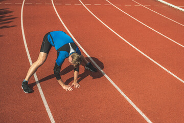 Young Caucasian man doing stretching  exercises, open legs