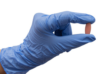 The doctor holds the medicine in a blue glove. Capsule in hand on an isolated background.
