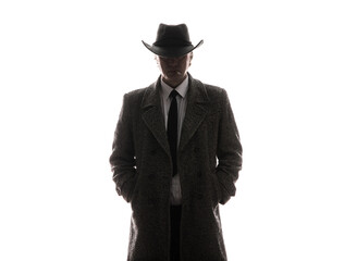 studio portrait of male businessman in gray coat and hat