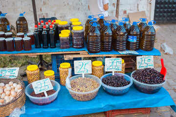 Selling Turkish olives in local market place in Turkey. Marinaded green and black olives in bazar.