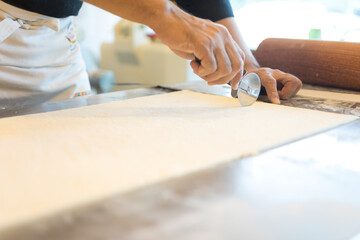 Hands baking dough with rolling pin on wooden table 
Hand, Cooking, Dough, Bread, Bakery,Croissant 