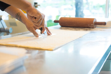 Hands baking dough with rolling pin on wooden table 
Hand, Cooking, Dough, Bread, Bakery,Croissant 