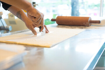 Hands baking dough with rolling pin on wooden table 
Hand, Cooking, Dough, Bread, Bakery,Croissant 