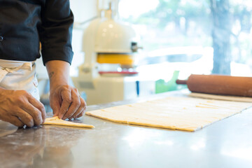 Hands baking dough with rolling pin on wooden table 
Hand, Cooking, Dough, Bread, Bakery,Croissant 