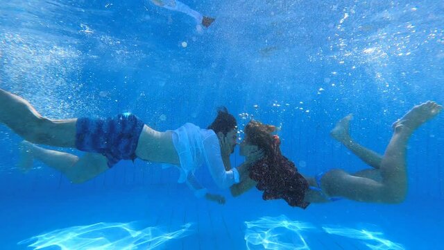 underwater shot of young couple kissing in the pool