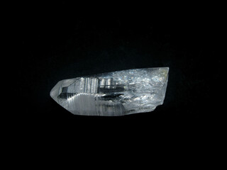 a piece of transparent rock crystal on a black background