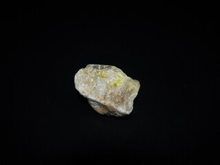 sample of native sulfur in dolomite on a black background