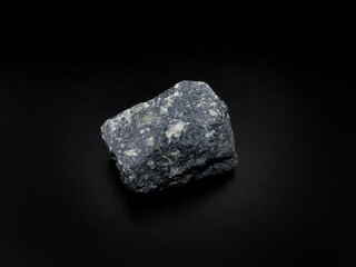 sample of a mineral from the Galena sulfide class on a black background