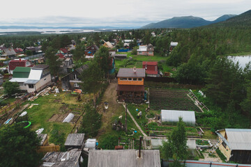 Fototapeta na wymiar Aerial Townscape of Suburban Village Sosnoviy Bor located in Russia near the town Kandalaksha