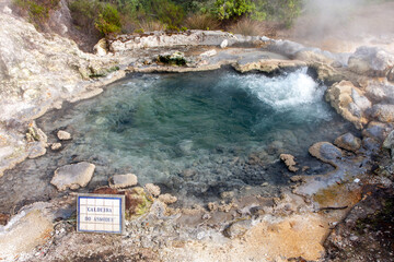 hot geyser with beautiful blue water gushing from the rocky ground, Furnas - Sao Miguel