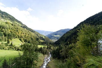 Fototapeta na wymiar Stream from the waterfall near city of Partschins, South Tirol, Italy.