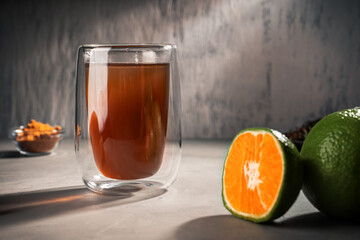 Black tea with green Mandarin oil in a double-walled glass