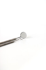Set of metal Dentist's medical equipment tools. White background top view copy space