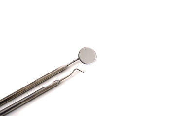 Set of metal Dentist's medical equipment tools. White background top view copy space