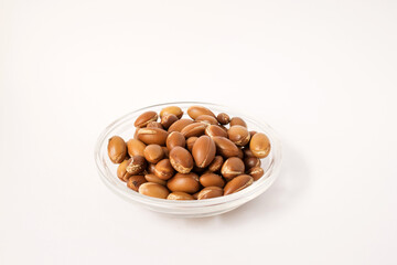 the nuts of the argan tree (Argania spinosa) on a white background. For the production of argan oil